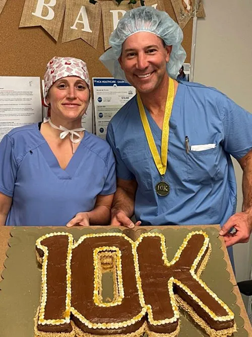 Dr. Goldberg and staff with 10k cake