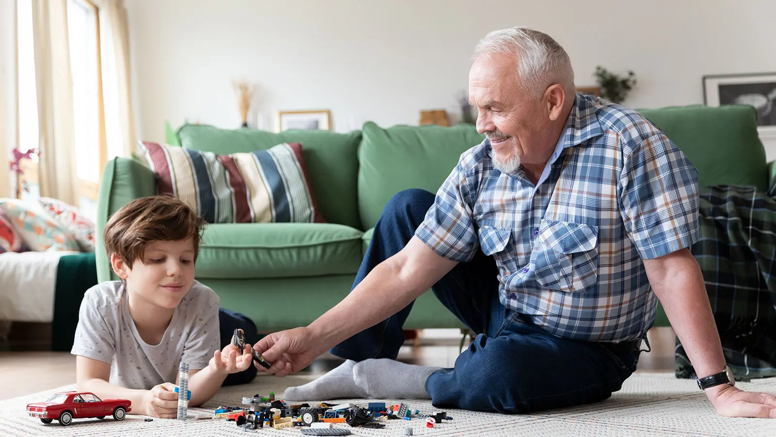 Grandpa playing Legos with grandson