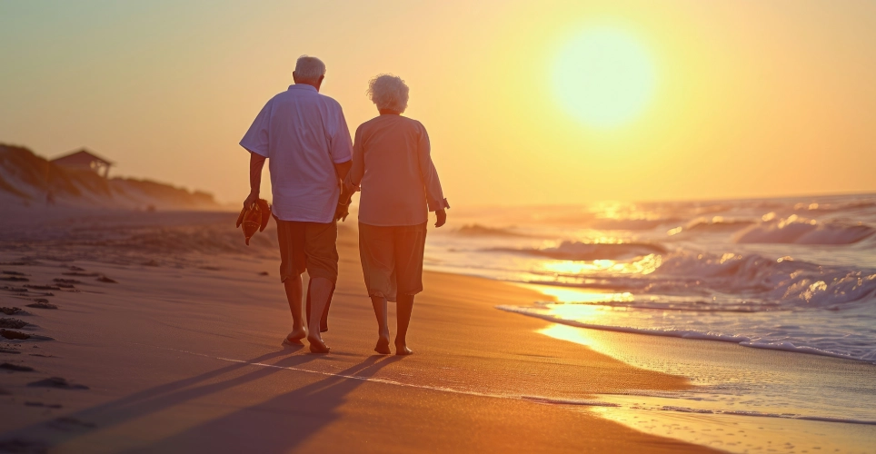 happy elderly couple walking on the beach2